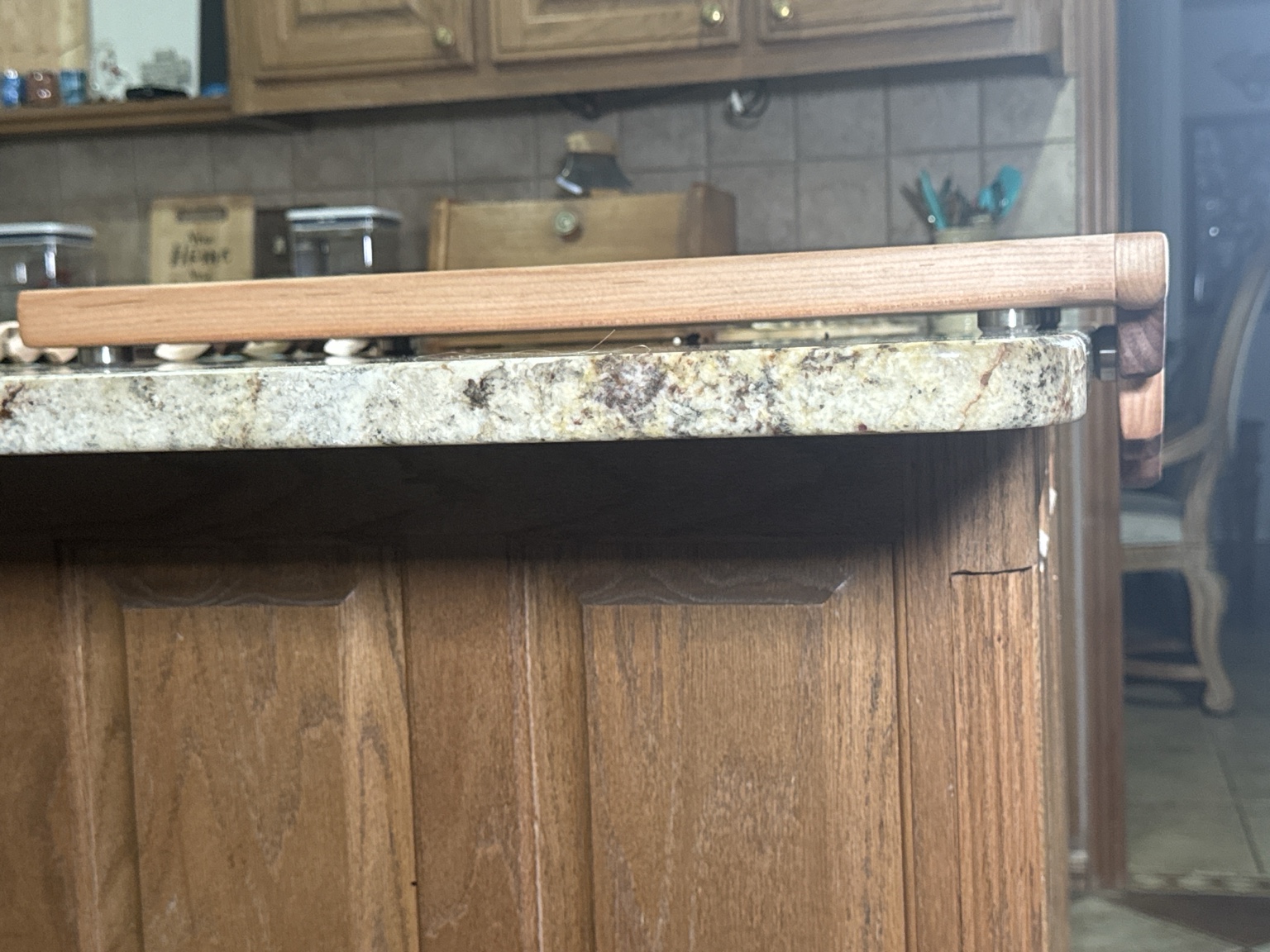 Side detail showing the Melted Edge board raised above the countertop on metal feet